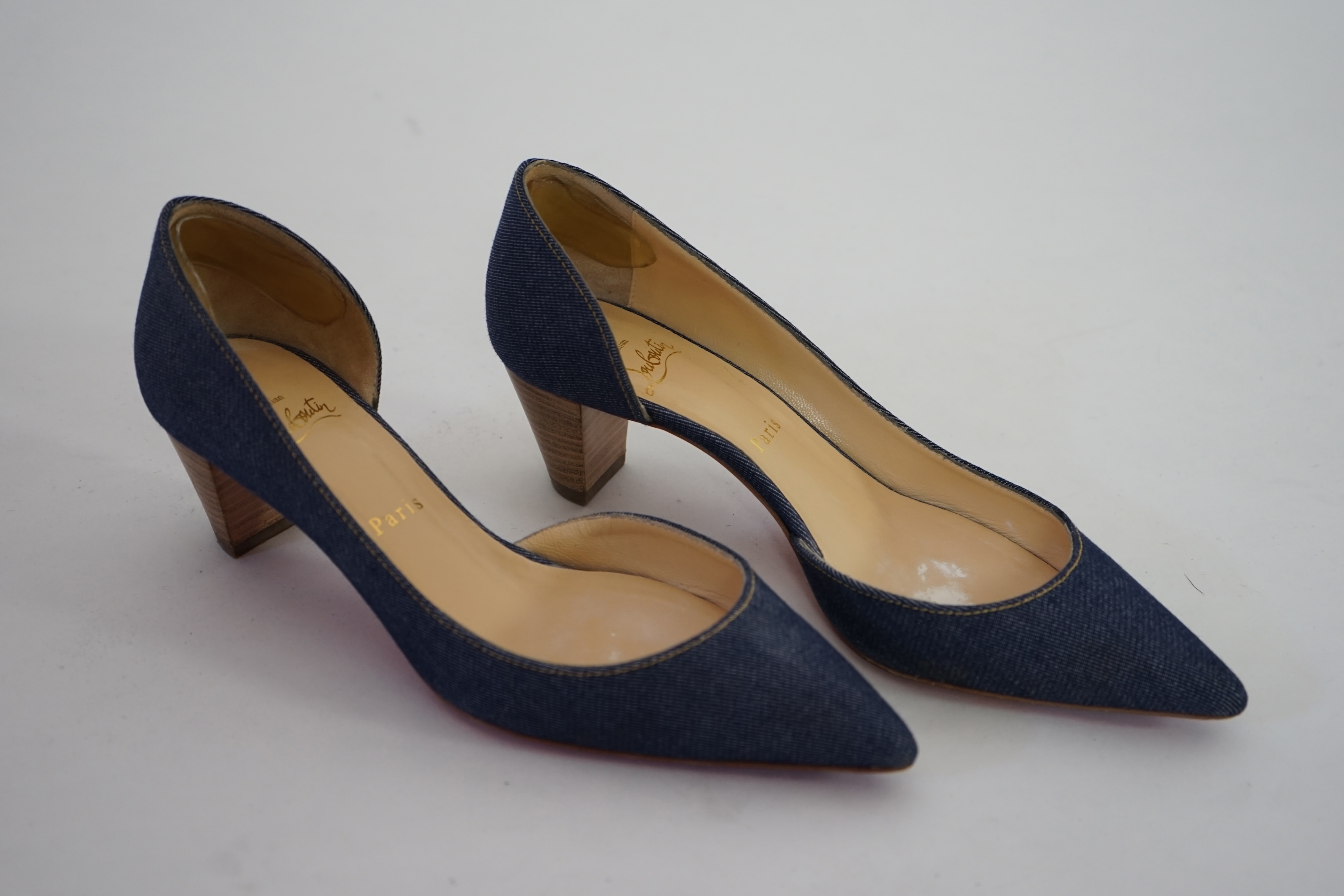 A pair of Christian Louboutin lady's denim pumps with wooden heels, comes with dust bag in original box. Size 39. Proceeds to Happy Paws Puppy Rescue